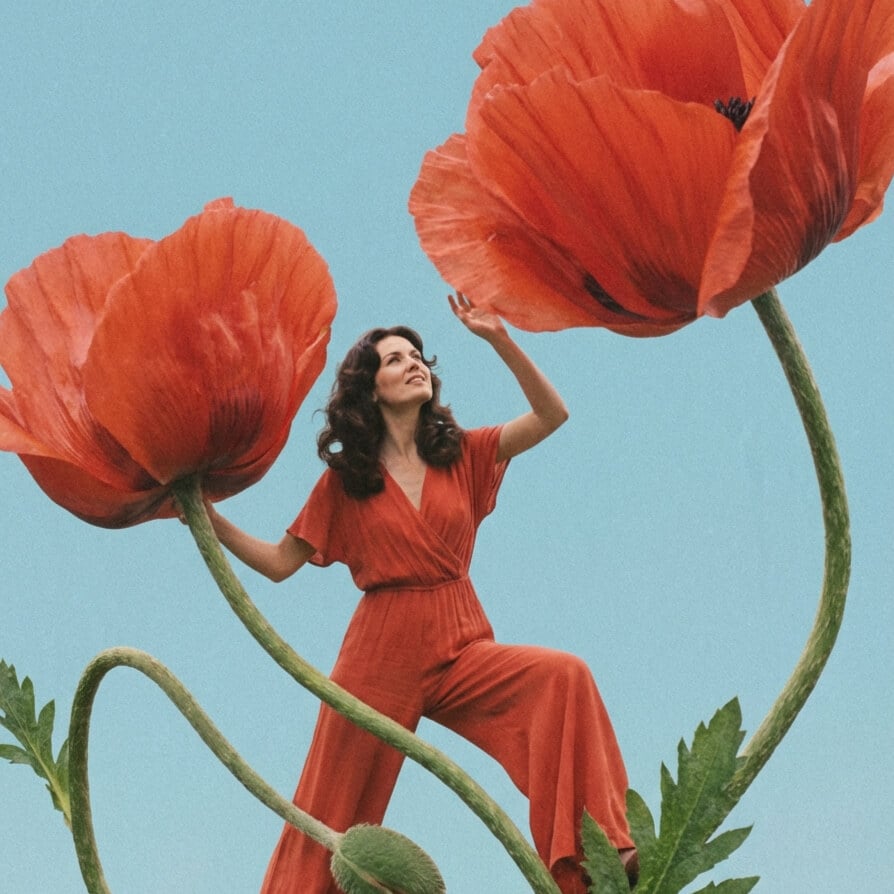 AI generated surreal fashion photo featuring oversized red flowers and a woman in a flowing dress