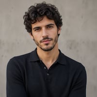 A thumbnail of a curly haired bearded man