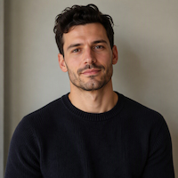 A thumbnail of a man with curly slicked back hair