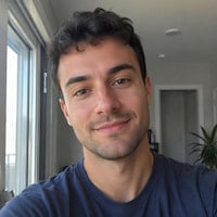 A thumbnail of a young man with black curly hair