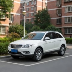 A white car in the parking lot of a residence thumbnail