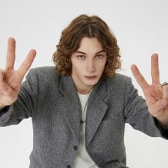 A young man making a yeah gesture thumbnail