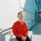 The thumbnail of a kid in red sweater