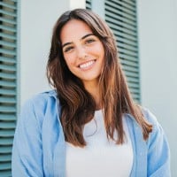 The thumbnail of a woman in blue blouse