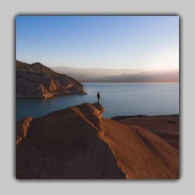 Adding a shadow photo frame to a landscape photo of a person standing on top of a mountain
