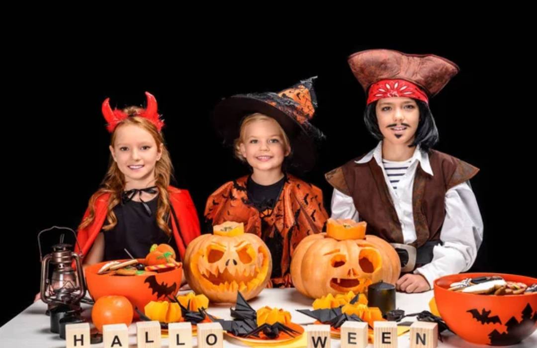 Three kids dressed up for Halloween at a Halloween party