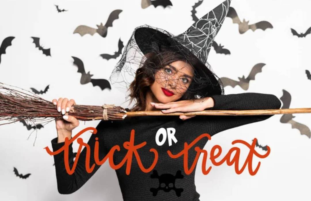 A halloween witch holding a broom