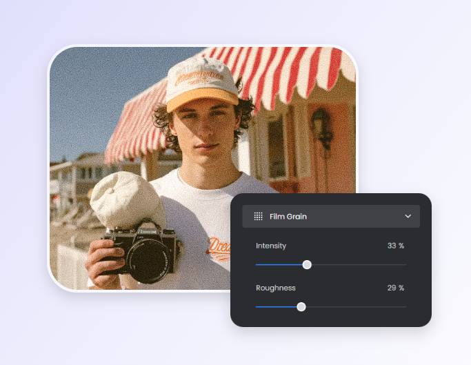Apply film grain effect to a photo of a man holding a camera using fotor