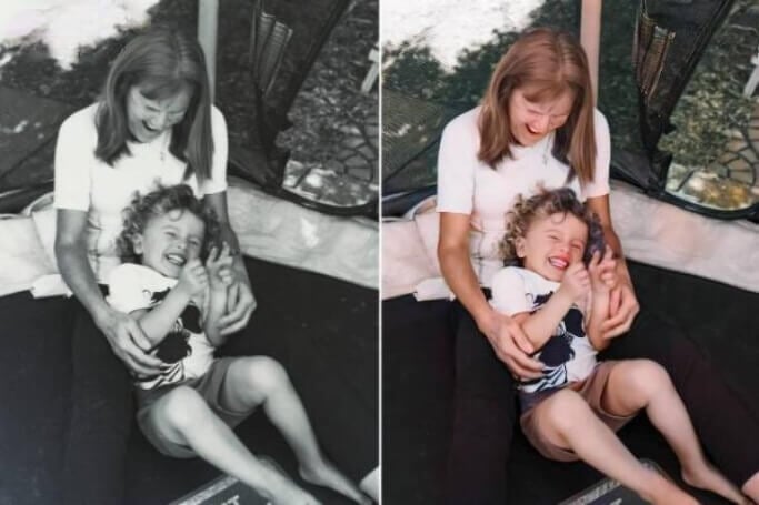 Restaurare una vecchia foto di un uomo che gioca con un bambino.