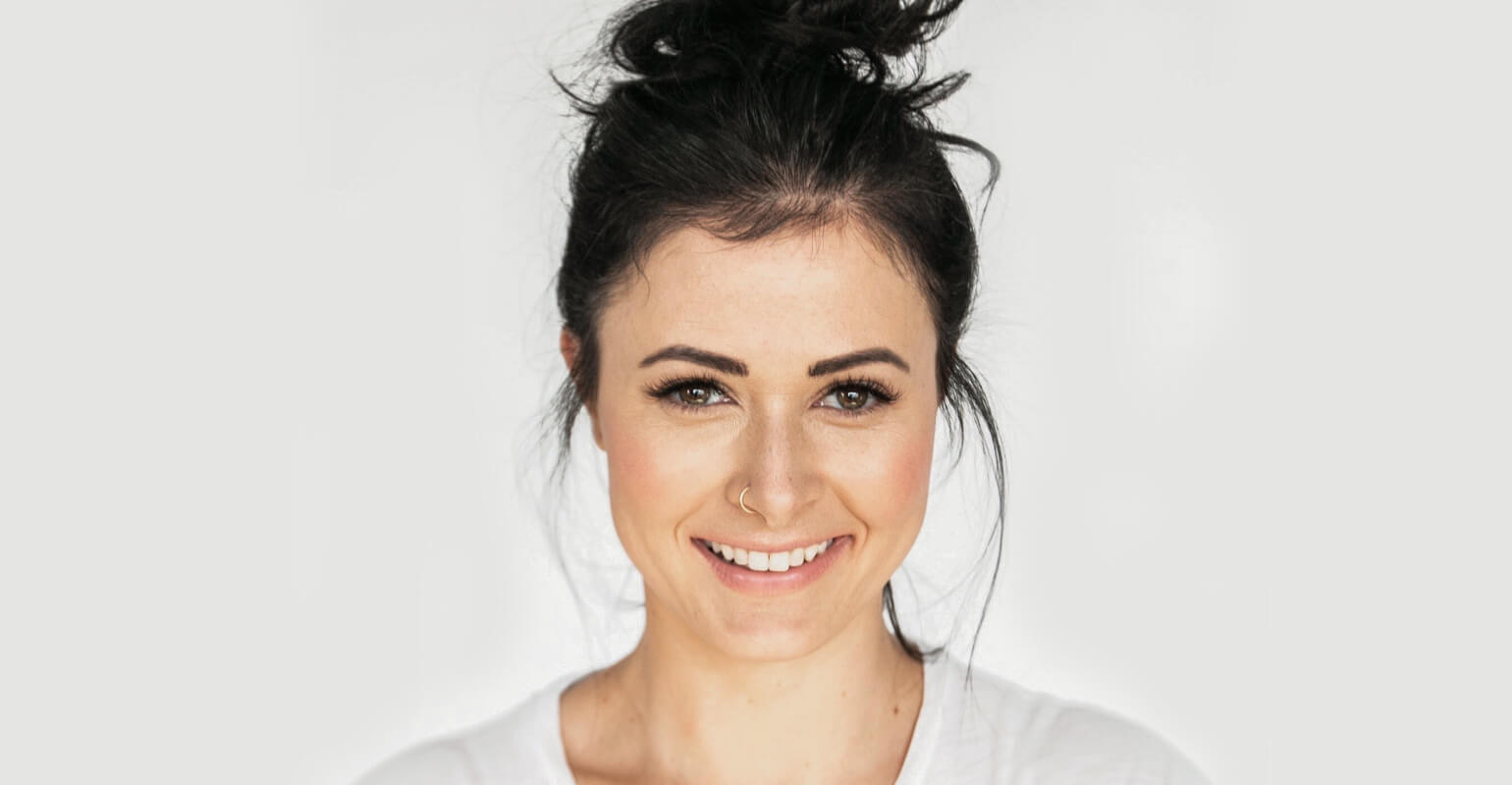 A smiling woman with her hair up