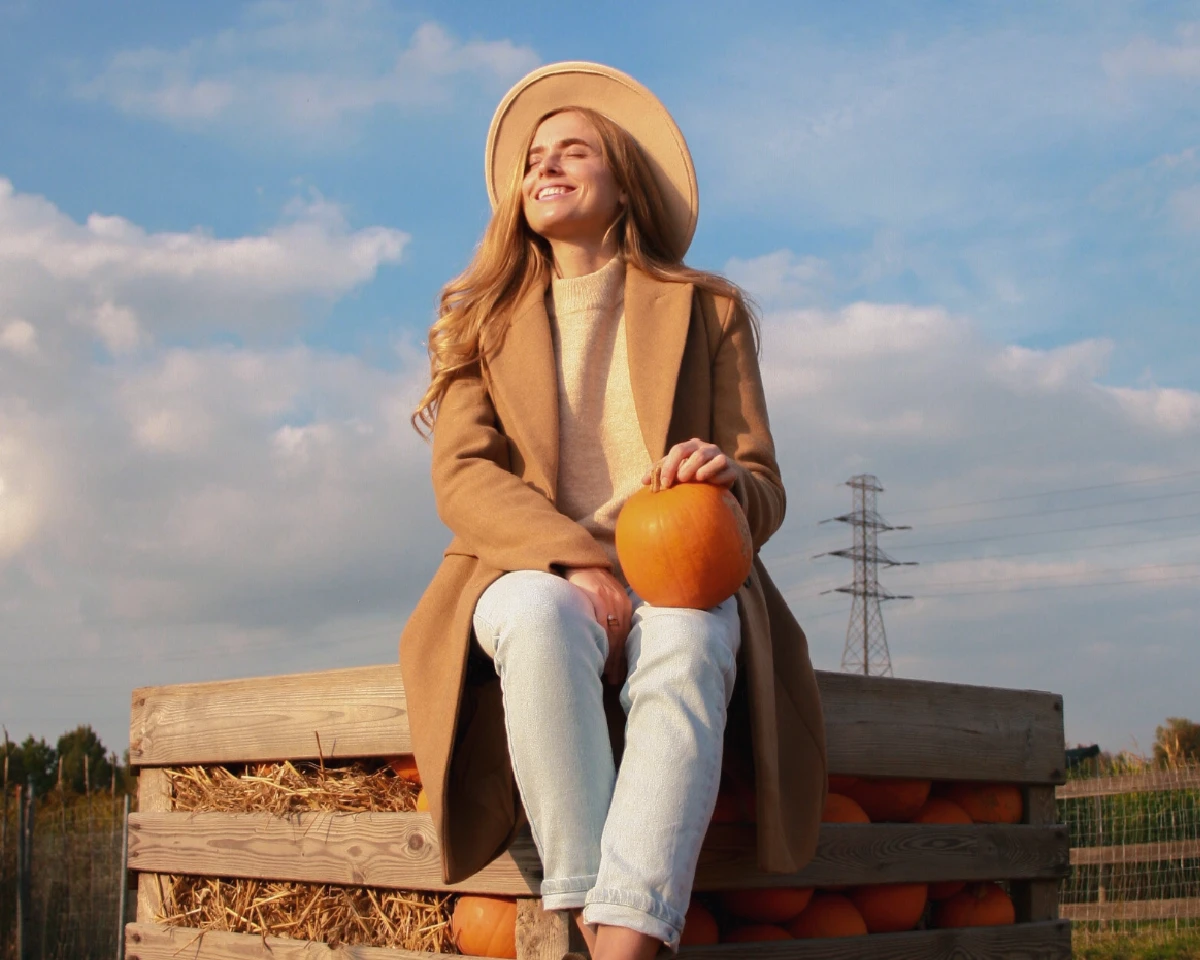 Photorealistic portrait of a woman under a bright blue sky with white clouds