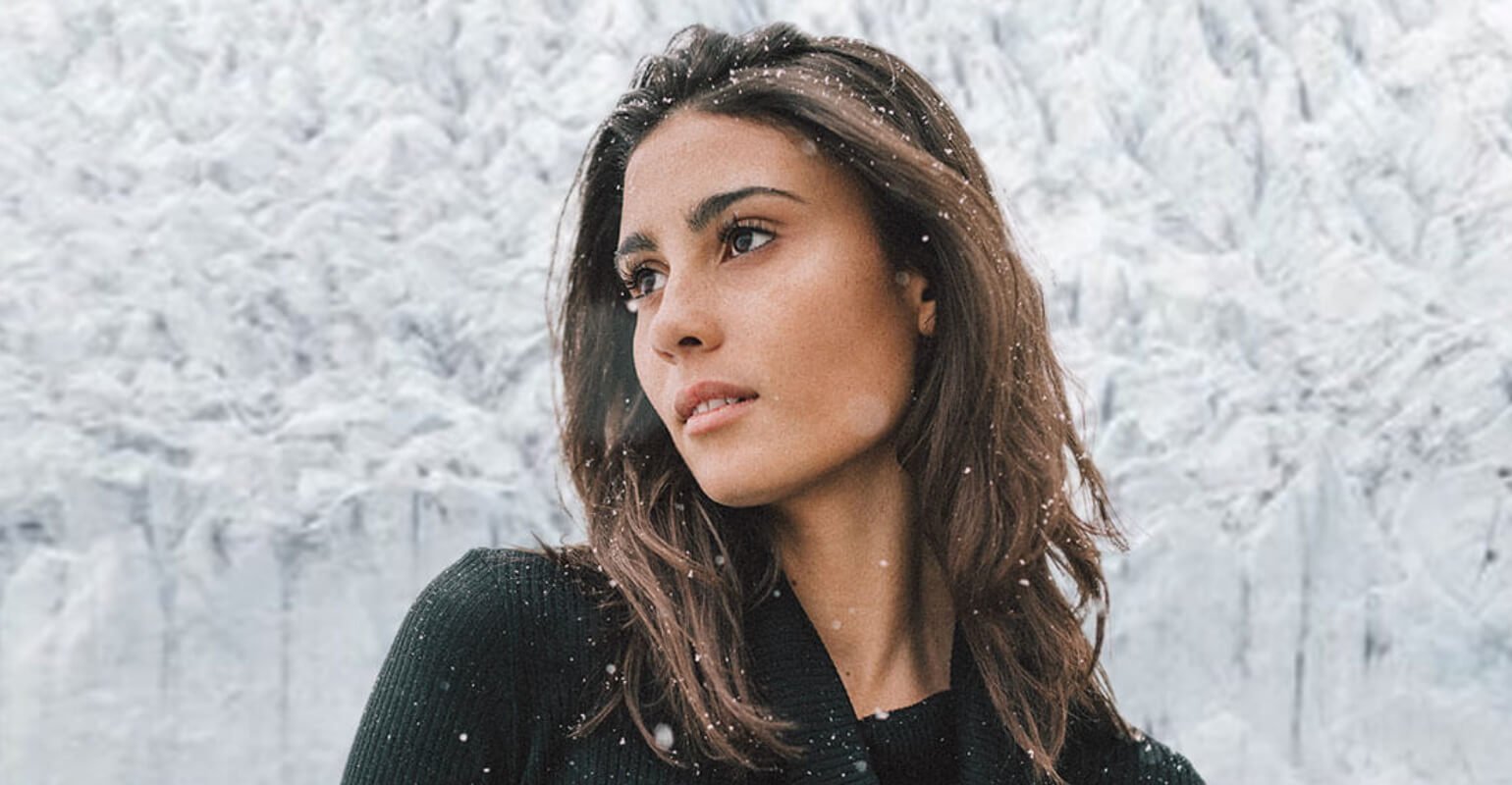A beautiful woman with black in snow