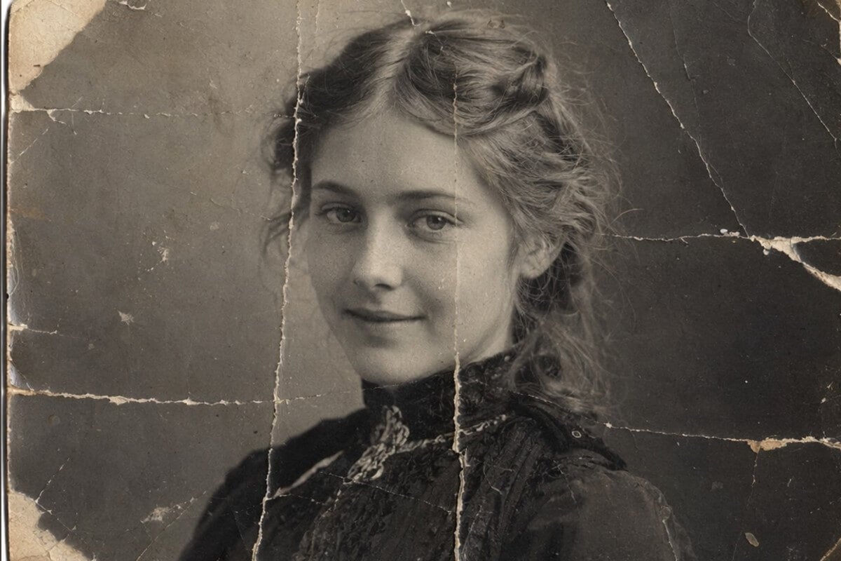 A damaged low quality old photo of a woman