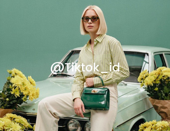 A fashion model video with a tiktok username