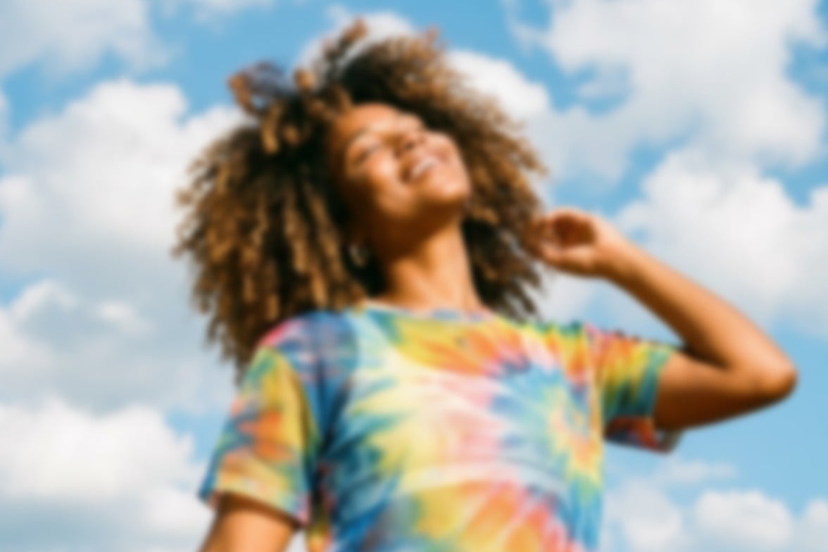 A low resolution original photo of a black woman wearing a colorful top