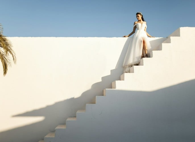 A picture of a lady standing on long stairs desktop version
