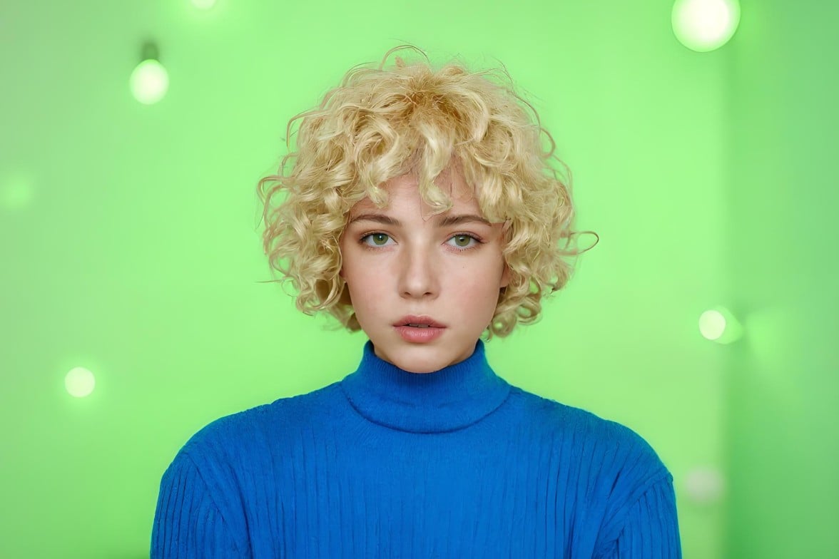 A woman with curly blonde hair wearing a blue top green background ai recolored