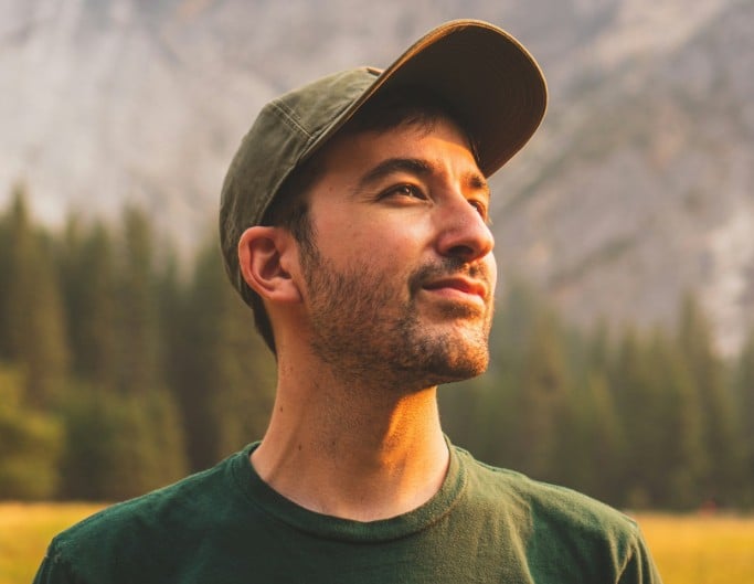An ai deblurred photo of a man wearing a hat