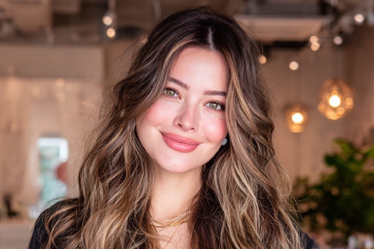 An edited photo of a woman with brown hair with blemishes removed
