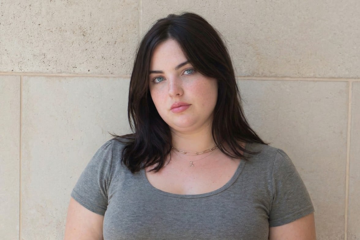 An image of a woman with black hair wearing a gray short sleeve shirt after applying fotor ai fat filter