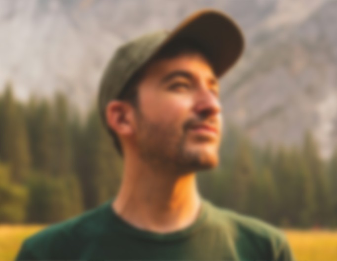 An original blurry photo of a man wearing a hat