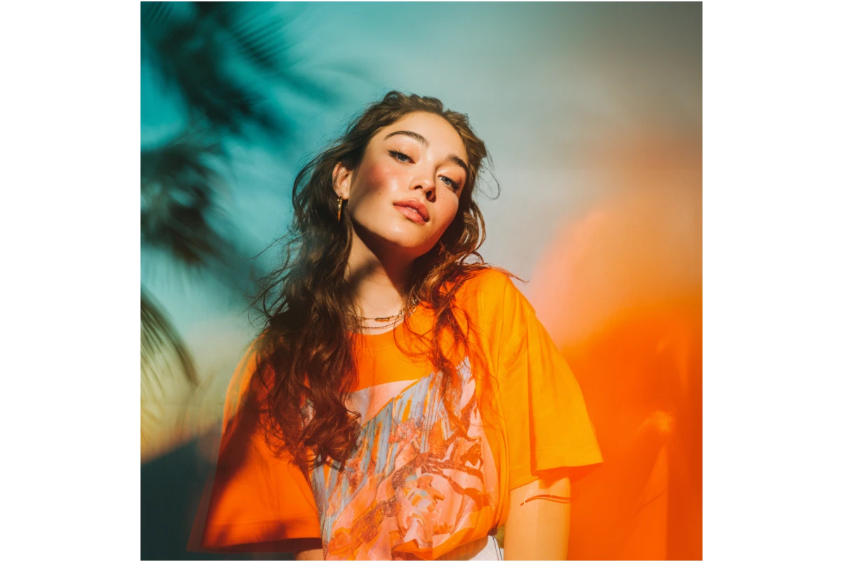 Extended square portrait of the woman showing the full T shirt graphic via Fotor AI expansion